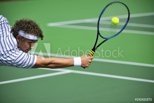 Picture of A tennis player stretches to make the shot